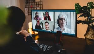 Multi generational business woman having video call with colleagues using computer app